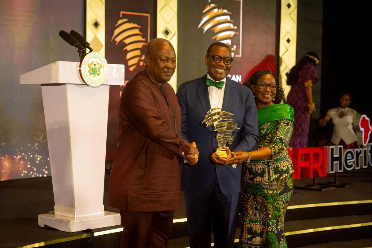 Dr Adesina holding award