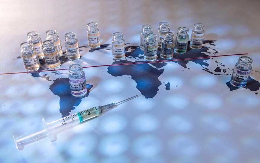 COVID vaccine vials on a world map