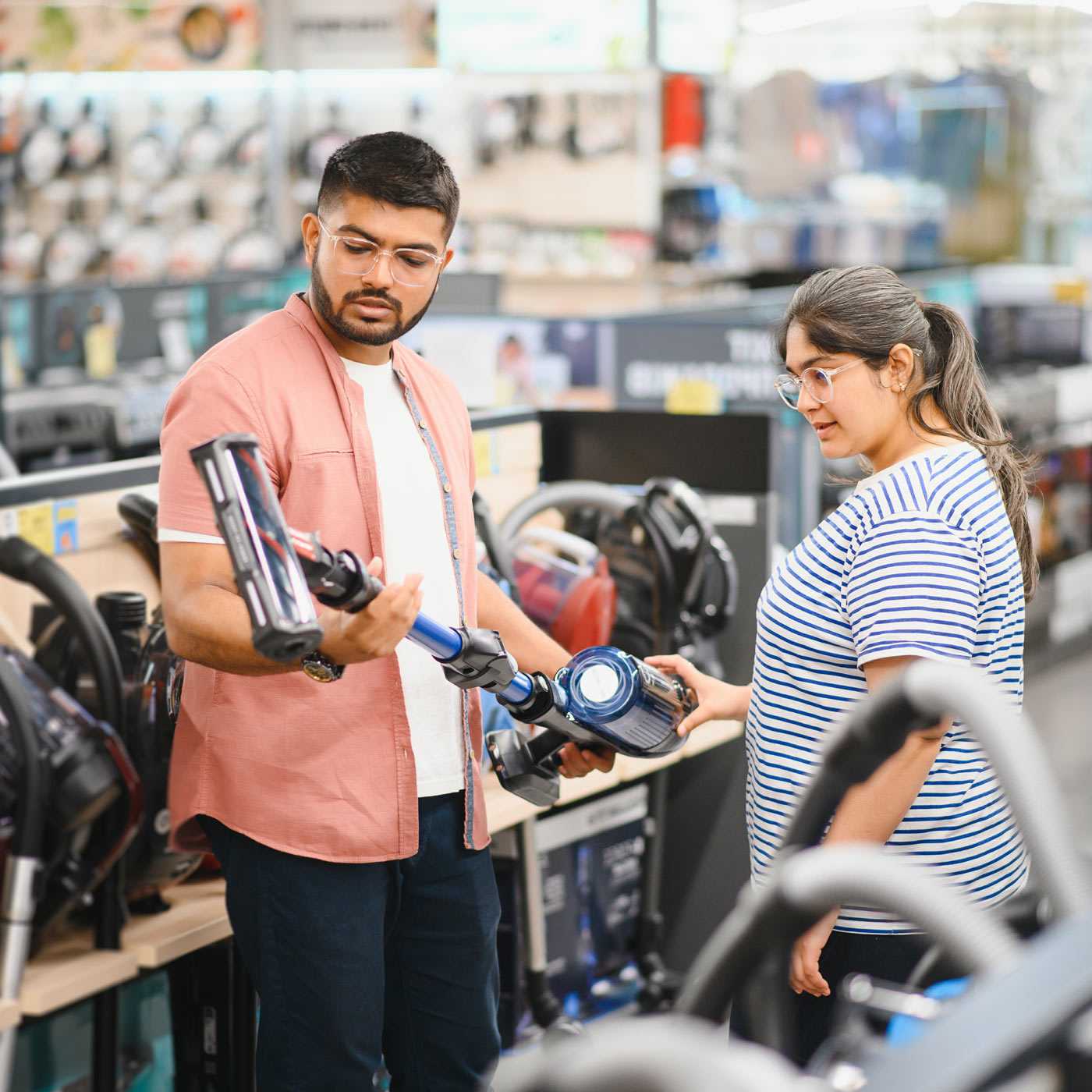 Couple shopping for vacuums