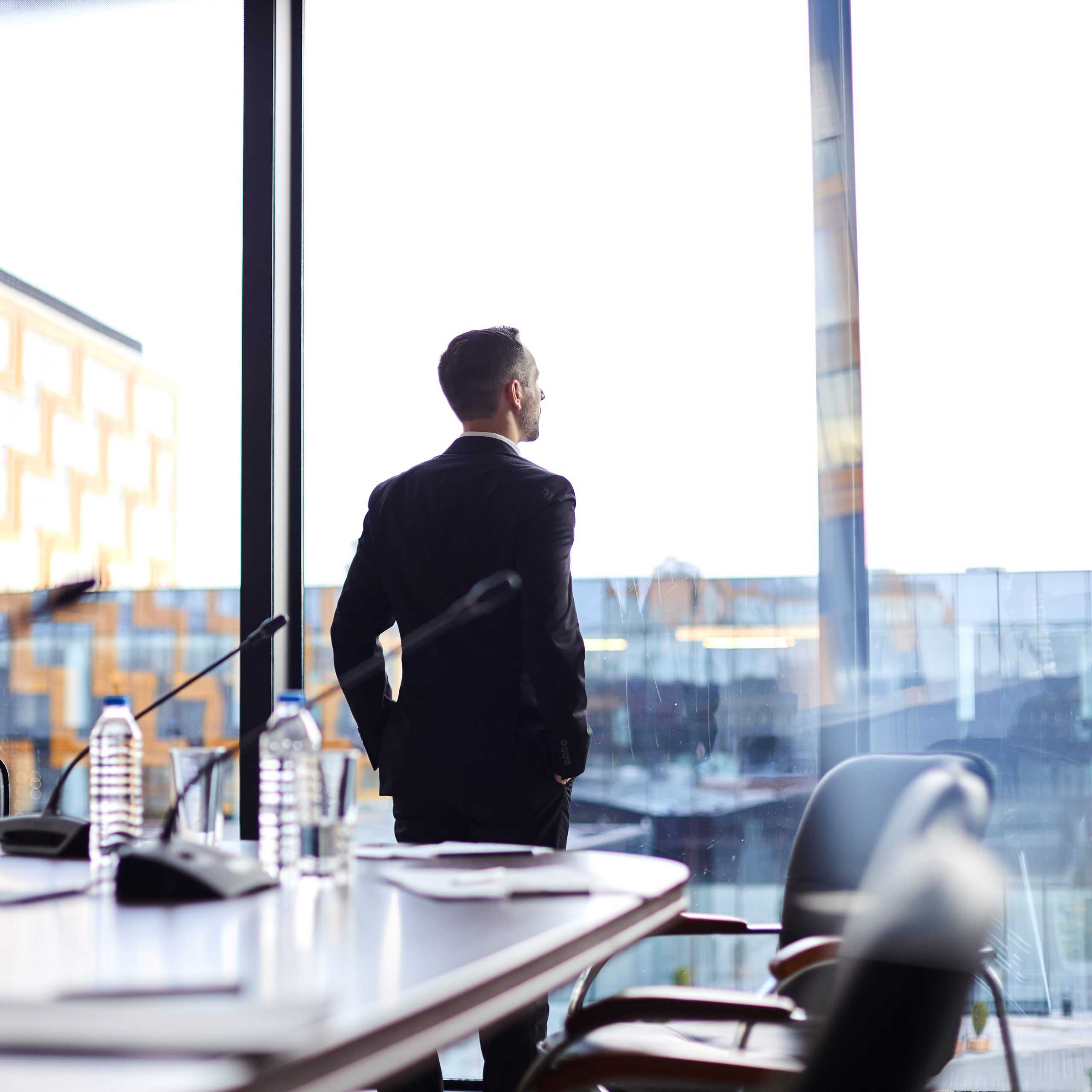 CEO in a high rise office thinking