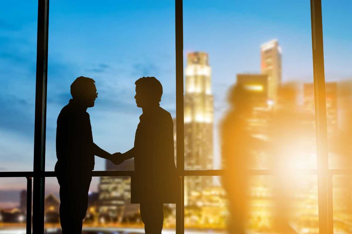 Dimly lit businessmen shaking hands