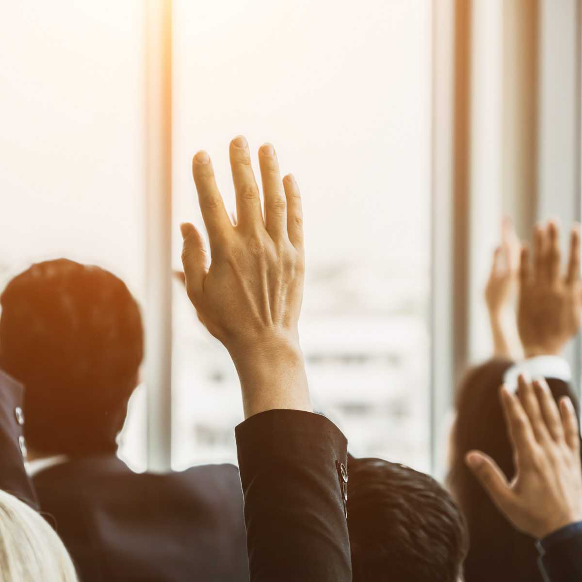 Business people raising hands