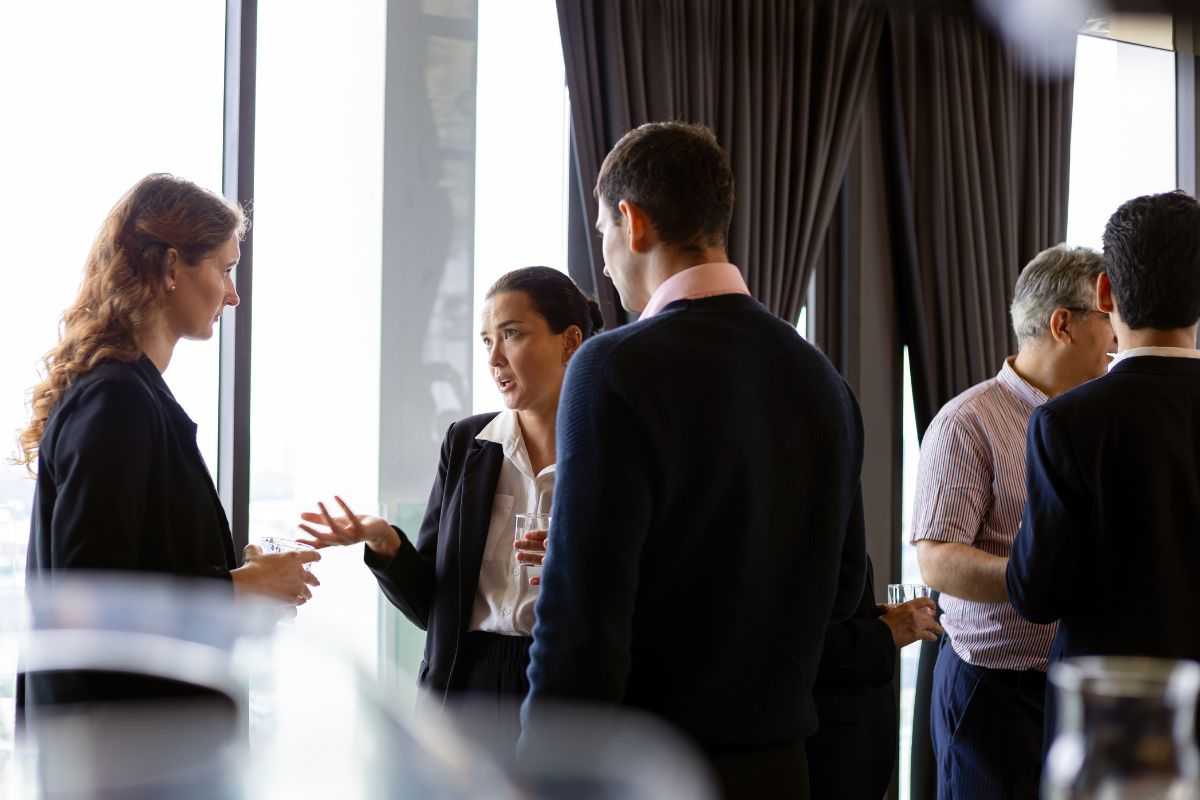 Business professionals converse and network at corporate event
