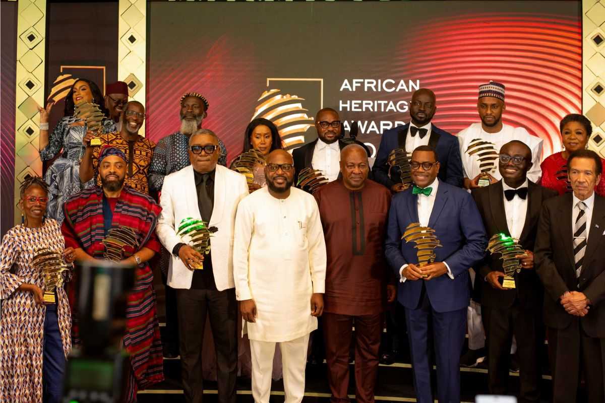 Dr. Adesina standing with award recipients