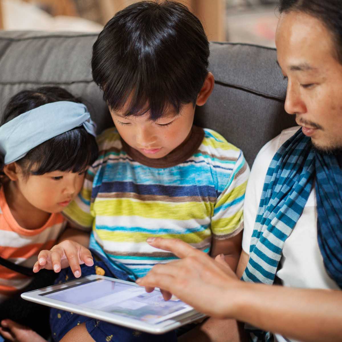 Japanese family looking at a tablet