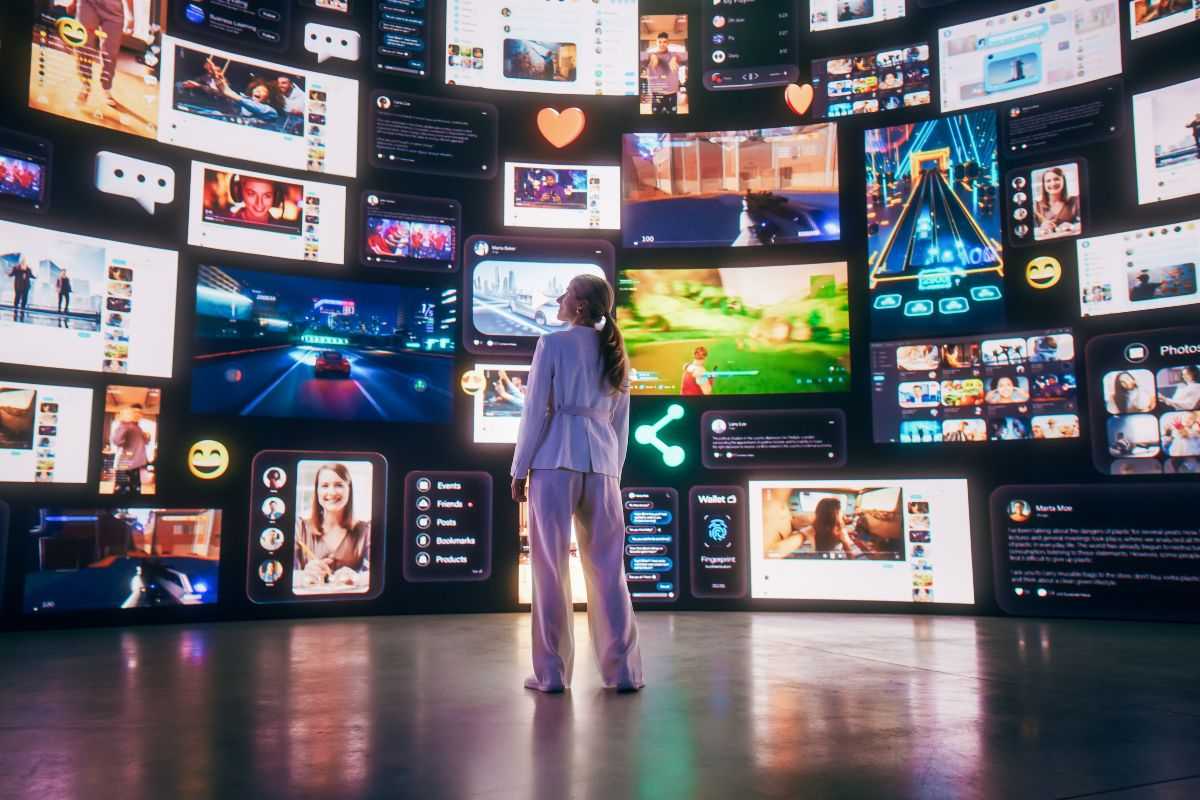 Woman standing in front of wall of screens