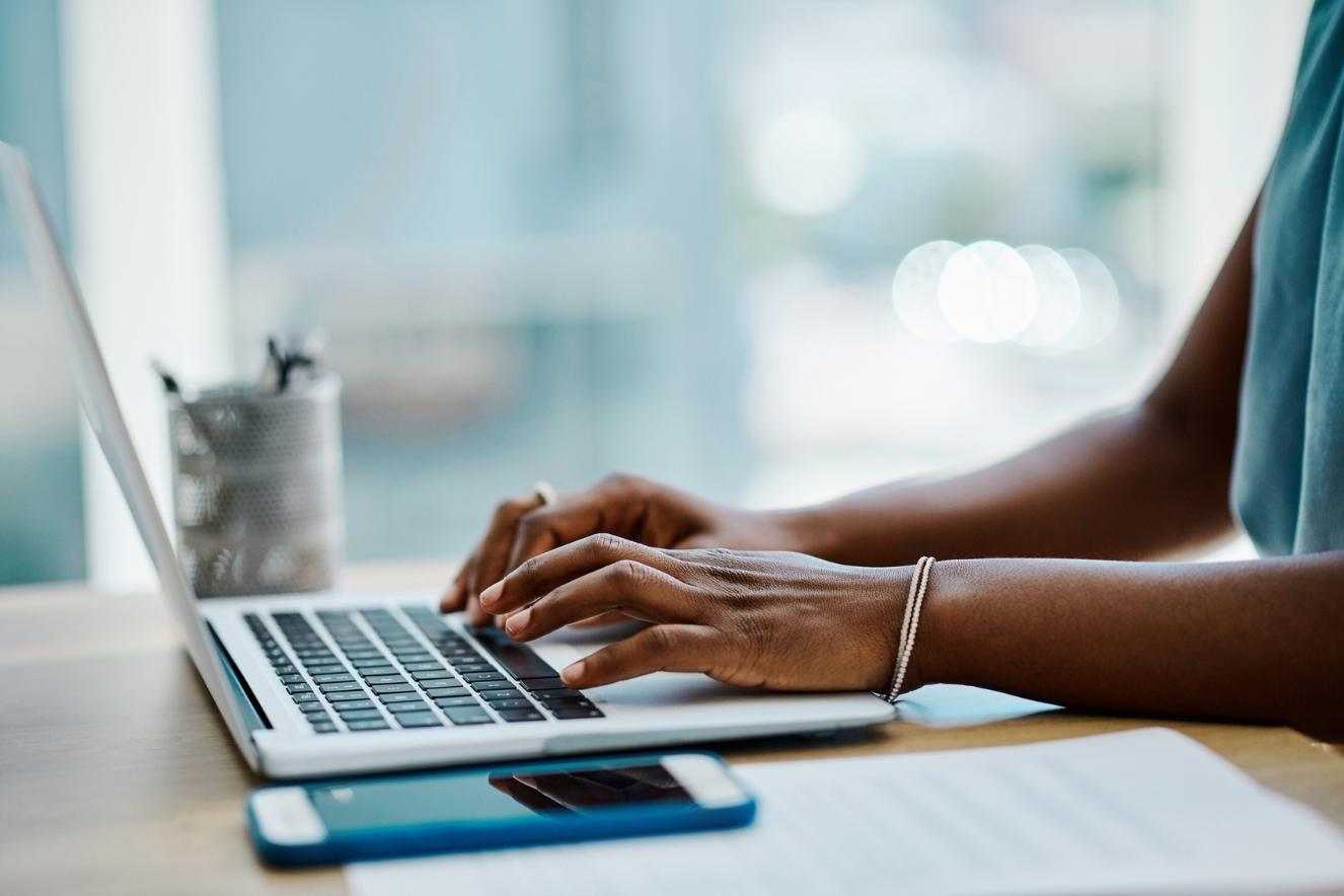 woman writing on a keyboard