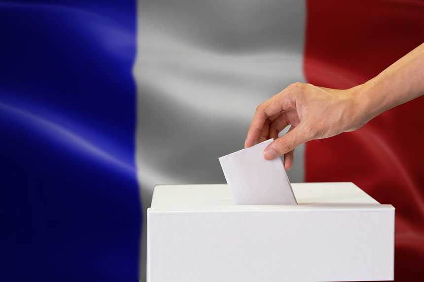 Ballot box with french flag behind it