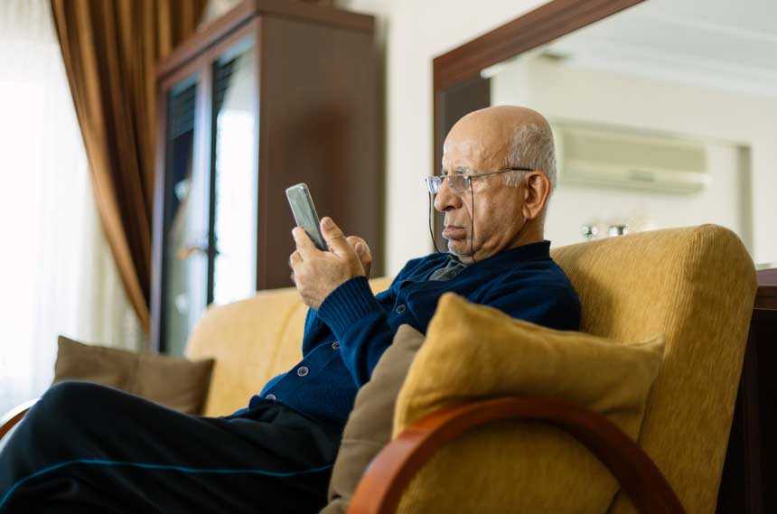senior man uses phone app