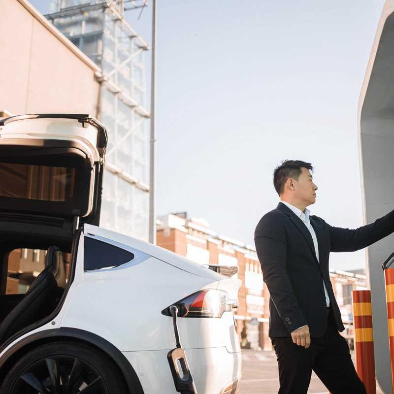 Man charging his electric vehicle (EV)