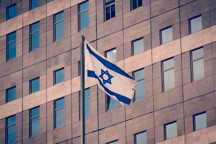 flag of Israel waving in front of building